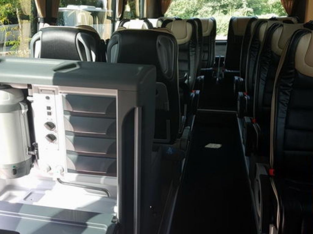 Komfortable und geräumige Sitzbereiche mit Tischen im Volvo Premium Bus.