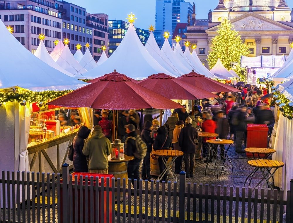 Lively Berlin Christmas market with people, lights, and a festive atmosphere